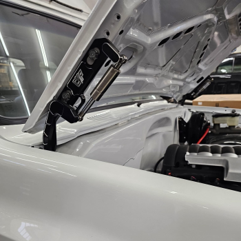 Black billet hood hinges shown installed on an 81-87 Chevy squarebody truck