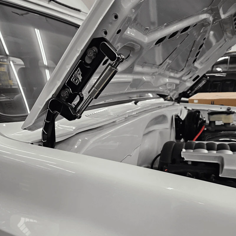 Black billet hood hinges shown installed on an 81-87 Chevy squarebody truck
