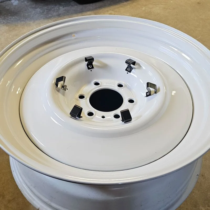 Dog dish hubcap held by universal hub cap clips on a Chevy truck wheel
