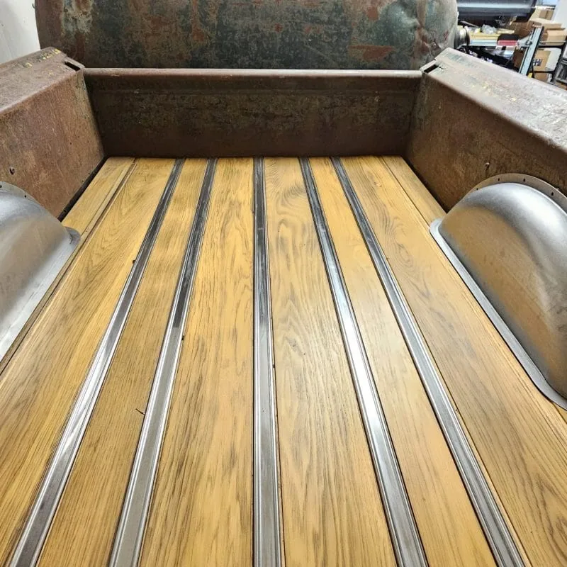 Truck bed wheel tubs shown installed on finished bed wood