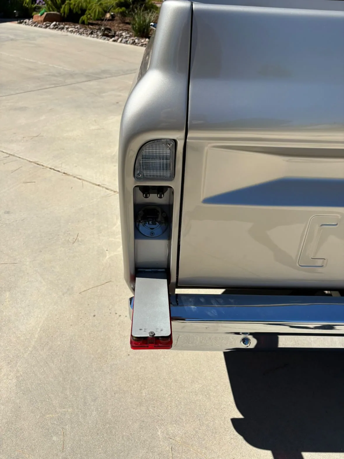 Polished stainless fuel filler neck in a 67-72 C10 taillight housing