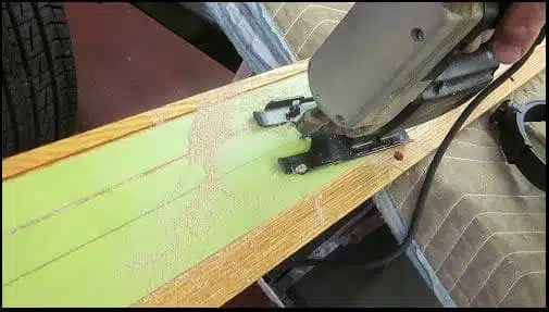 Jigsaw cutting bed floor board around wheel tub