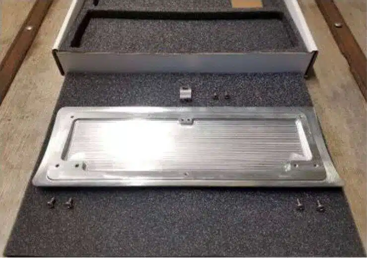 Backside of billet speaker grille with hardware locations