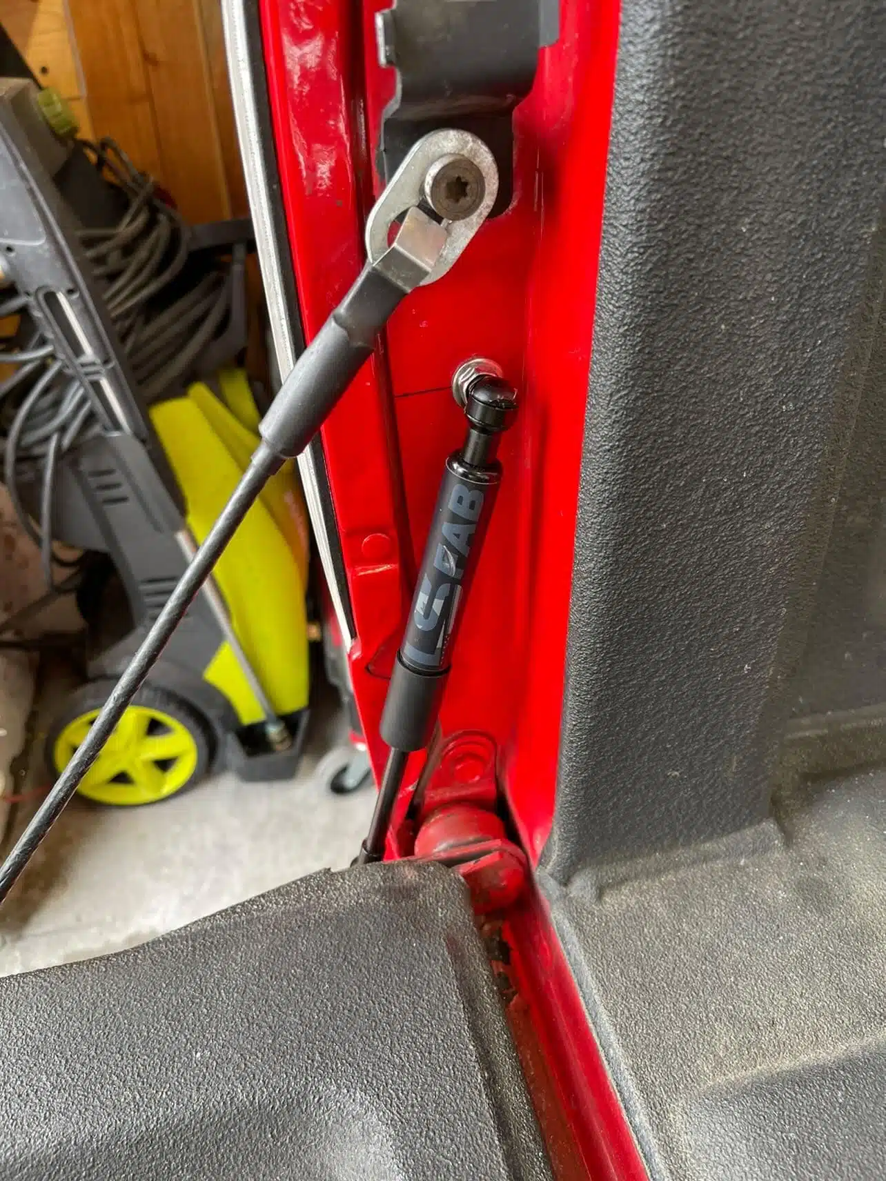 Tailgate saver strut mounted at the tailgate hinge on an 88-98 Chevy OBS truck