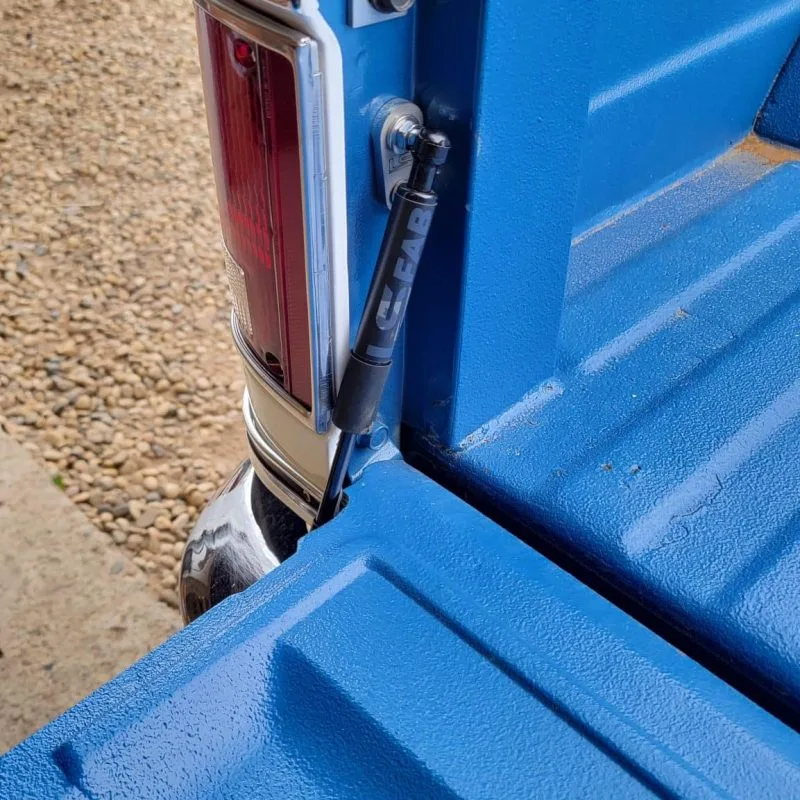 Tailgate saver shock strut shown installed on a 73-87 Chevy squarebody truck