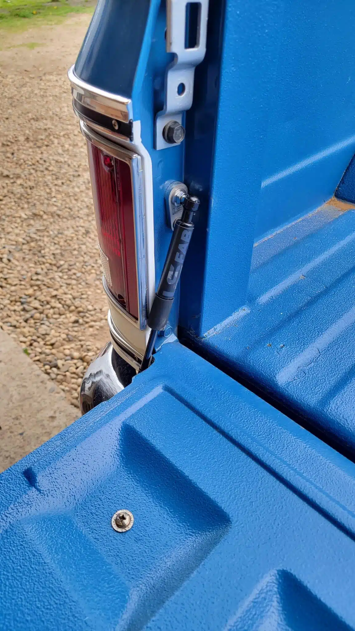 Tailgate saver shock strut shown installed on a 73-87 Chevy squarebody truck