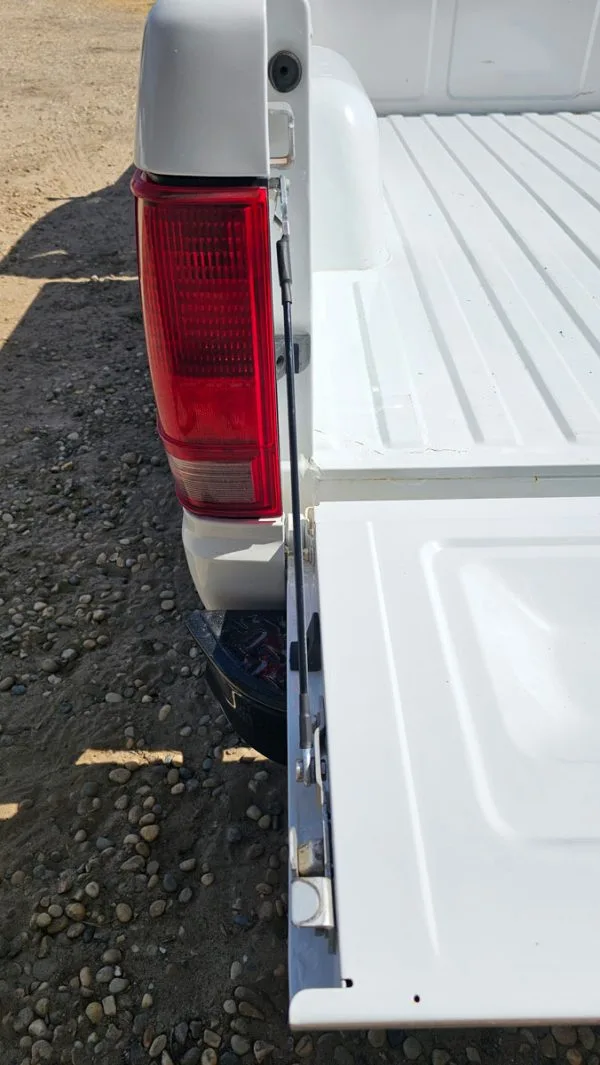 Tailgate cables shown installed on an 82-94 GMC Chevy S10 truck