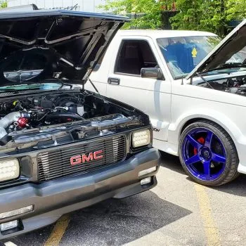 83-93 hood strut kit installed on white and black chevy truck