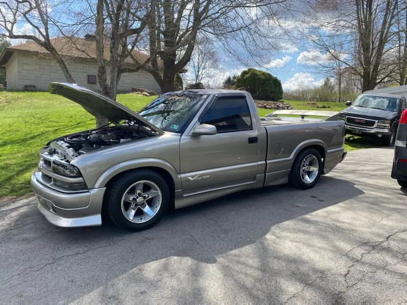 Hood strut kit shown installed on a pewter 94-04 Chevy S10 truck