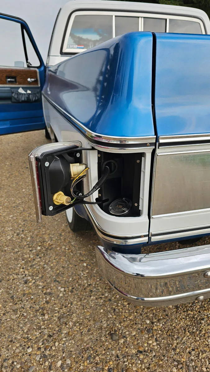 installed chevy taillight fuel filler on a square body truck open