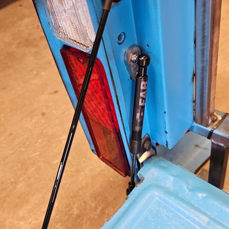 Tailgate shock strut and cables for chevy squarebody truck installed