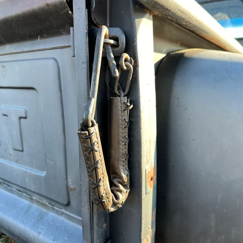 Tailgate chain covers installed on an open pickup tailgate