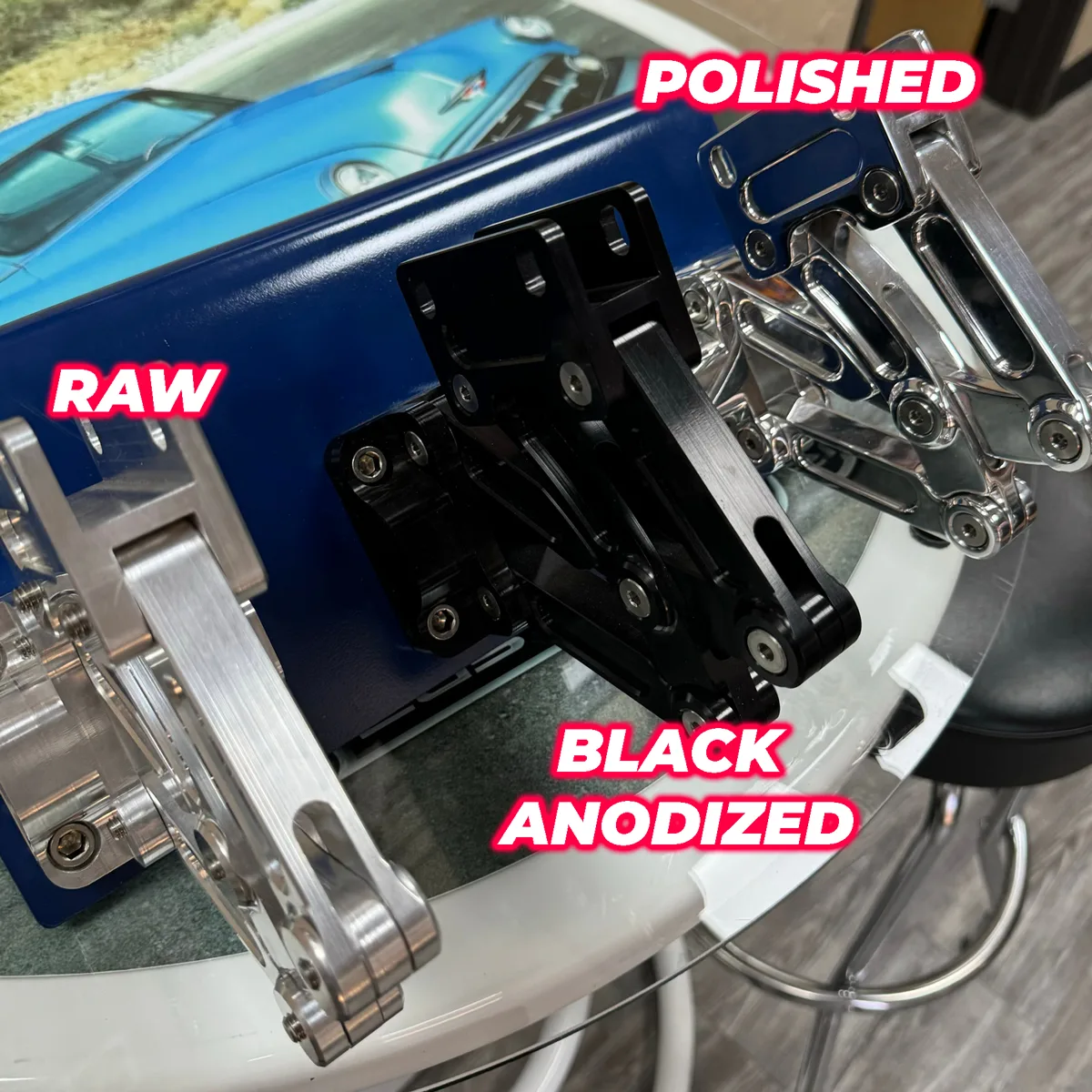 Billet aluminum tilt bed hinge shown open on a display stand