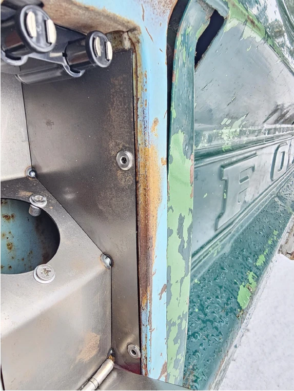Fuel filler bucket installed behind the taillight opening