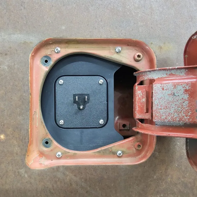 Fuel filler charger port for 77-91 GMC Chevy truck, close-up of the mounting flange
