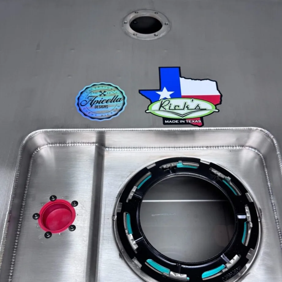 Close-up of stainless fuel tank pump sump with in-tank pump lock ring and fuel sender port
